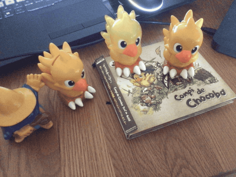 Three plastic chocobos, one plastic Black Mage, and a copy of the CD album 'Compi de Chocobo'